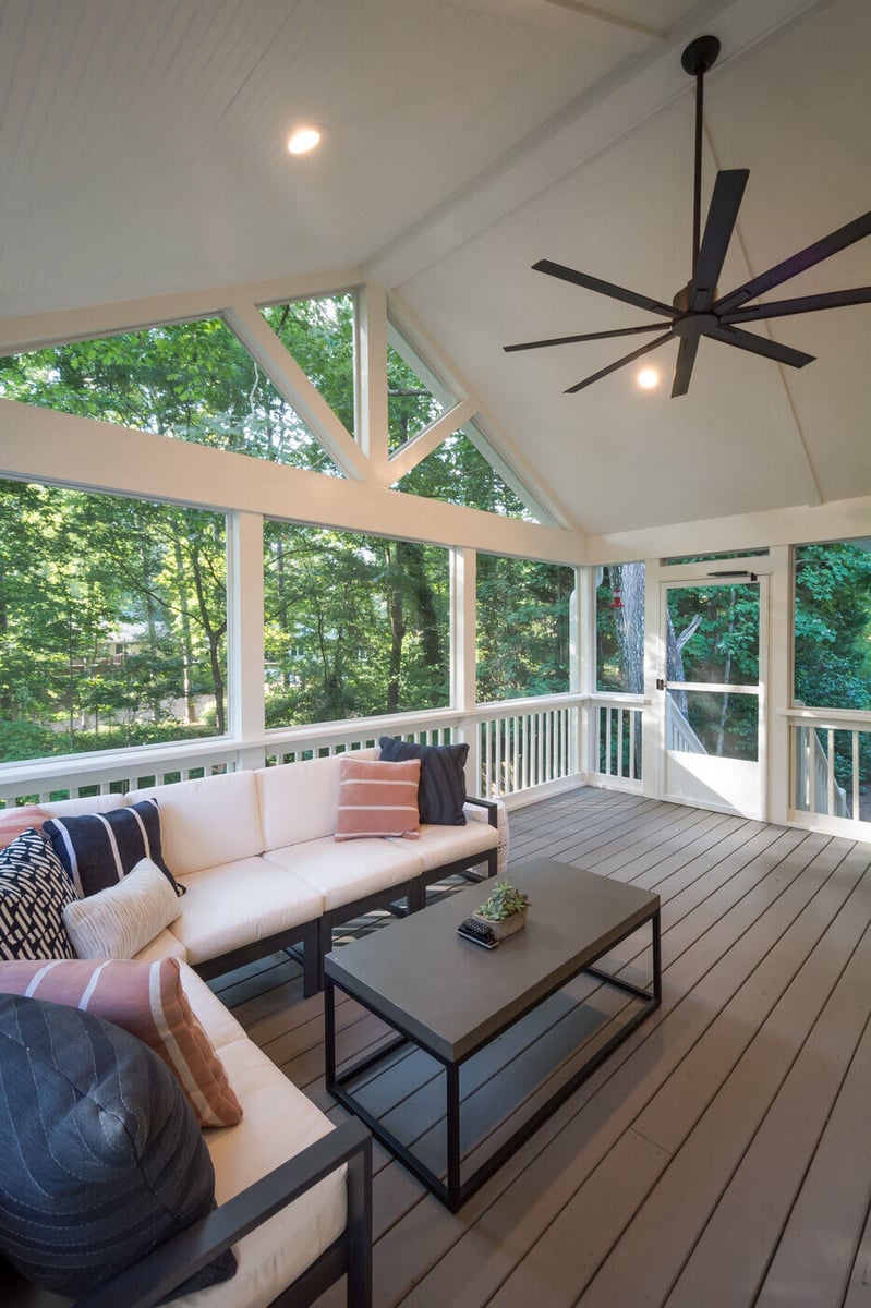 Bright screened-in porch with modern ceiling fan and sleek furniture in Atlanta, GA by Silver Oak Remodel