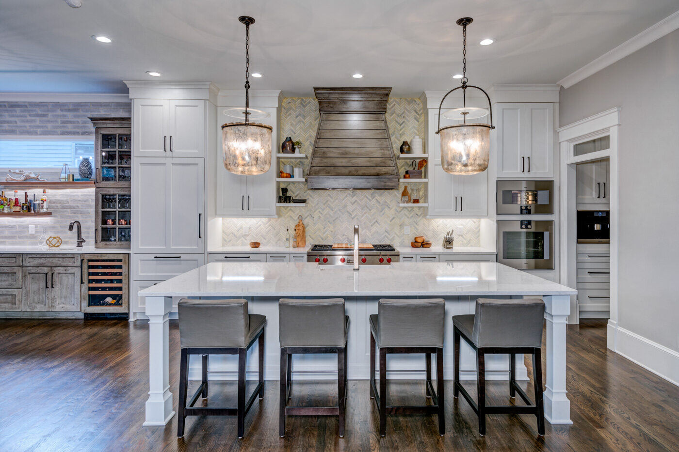Farmhouse-style kitchen remodel in Atlanta, GA by Silver Oak Remodel with wood vent hood and open shelving