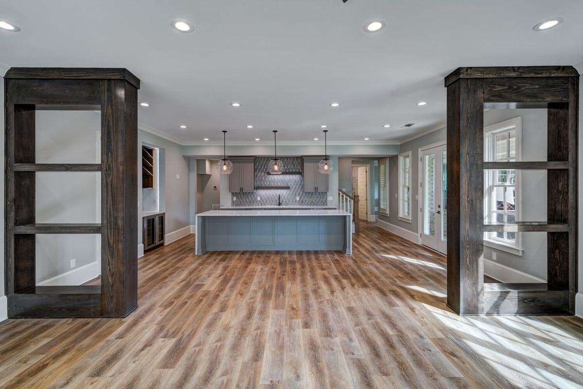 Open-concept basement kitchen and living area with large island by Silver Oak Remodel in Greater Atlanta