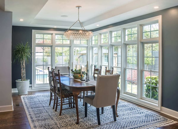 Corner dining space with crystal chandelier in Atlanta remodel by Silver Oak Remodeling