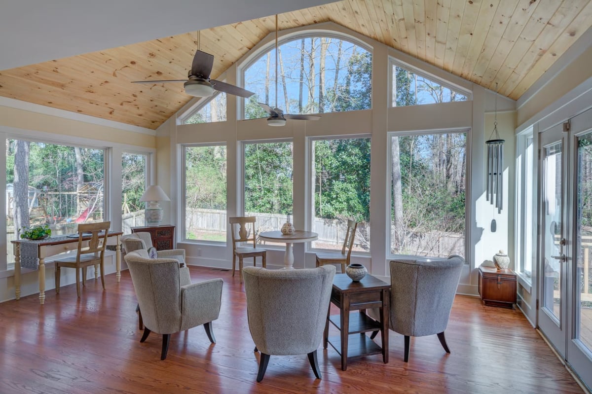 Sunroom with wood ceiling and large windows in Atlanta custom home by Silver Oak Remodeling
