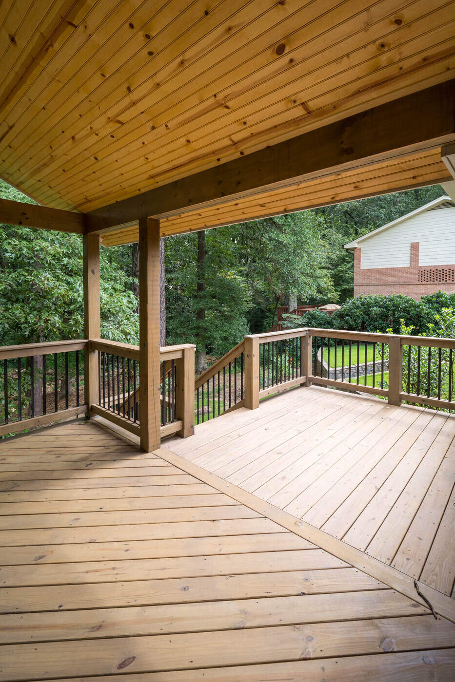 Open view of wood deck remodel with stairs leading to backyard by Silver Oak Remodel in Atlanta, GA