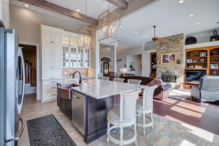Atlanta kitchen remodel by Silver Oak Remodel with stone fireplace and open living integration