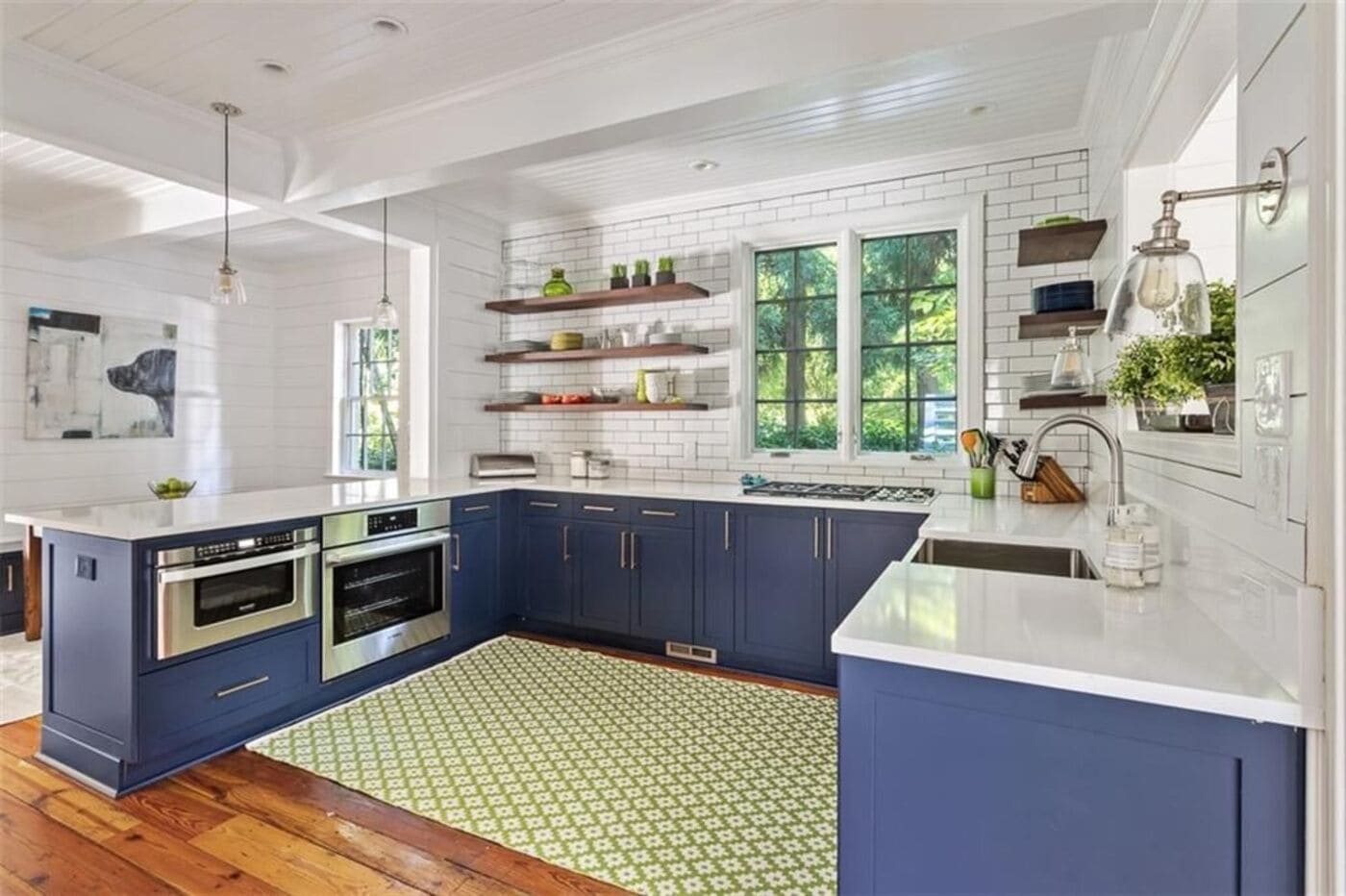 Blue and white kitchen renovation featuring natural light and open shelving by Silver Oak Remodeling in Atlanta