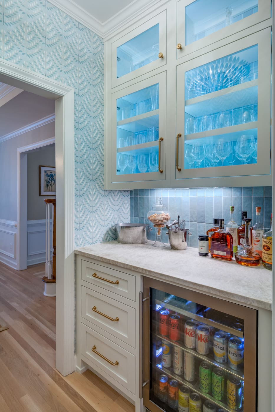 Built-in bar area featuring blue tile backsplash and undercounter fridge by Silver Oak Remodeling in Atlanta