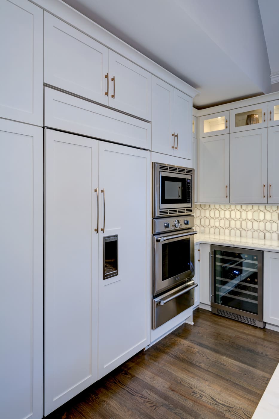 Built-in fridge and double oven with white shaker cabinets in Atlanta kitchen by Silver Oak Remodeling