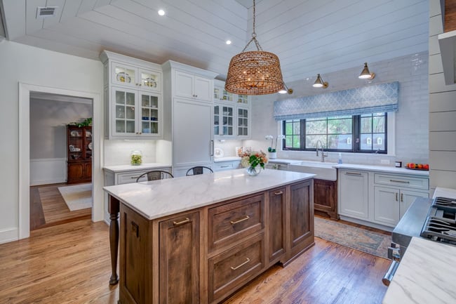 Classic white kitchen with wood island and pendant light in Atlanta custom home by Silver Oak Remodeling