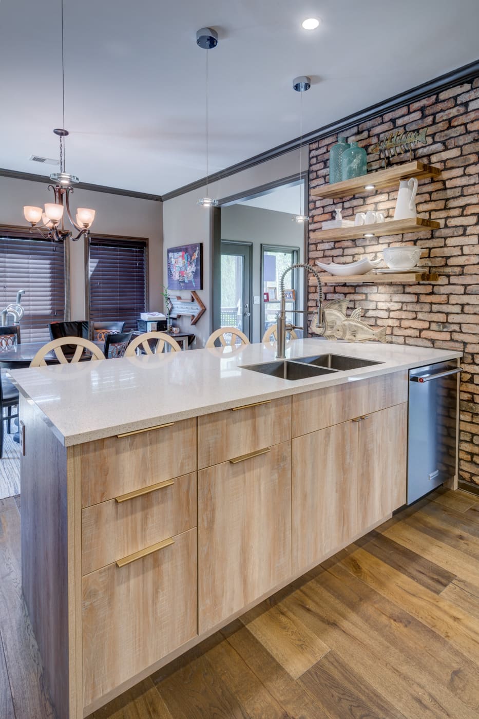Contemporary kitchen island with pendant lighting and natural textures by Silver Oak Remodeling in Atlanta