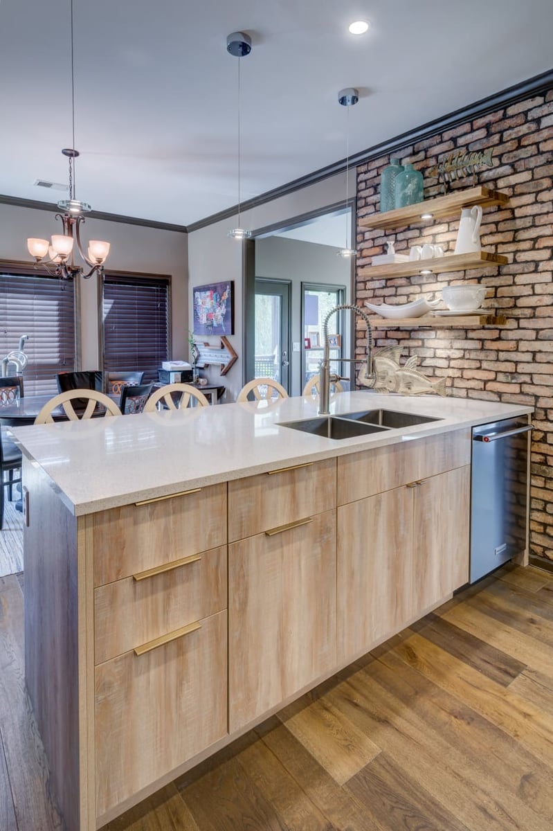 Contemporary kitchen island with pendant lighting and natural textures by Silver Oak Remodeling in Atlanta