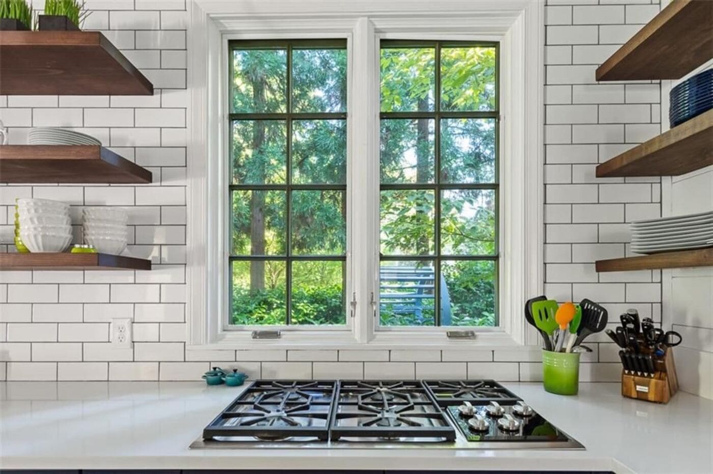 Crisp kitchen update with green utensil holder and tile backsplash by Silver Oak Remodeling in Atlanta, GA