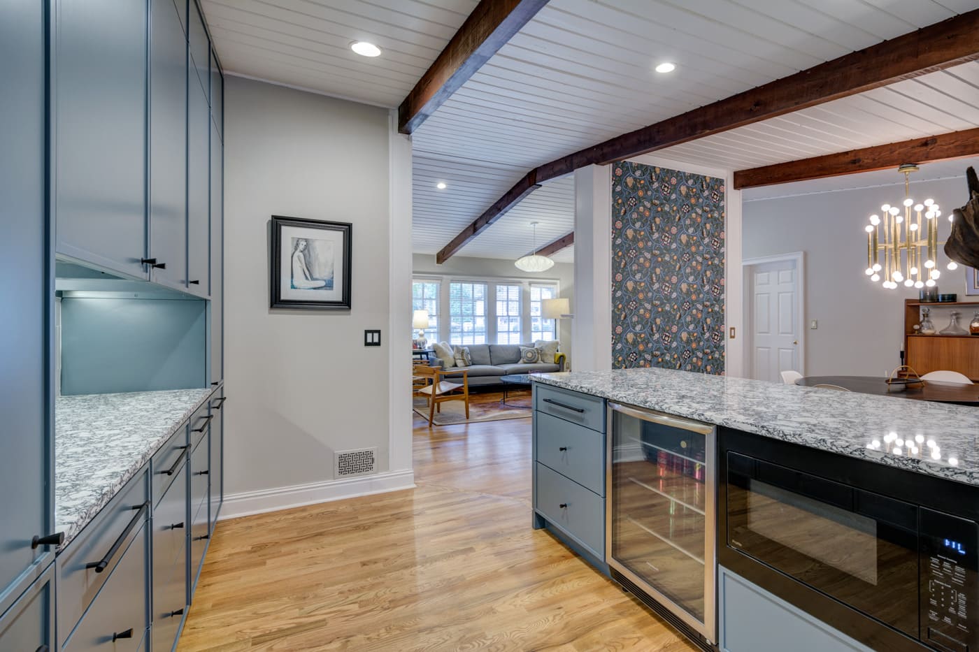 Custom kitchen design with large granite island and glass cabinetry by Silver Oak Remodeling in Atlanta, GA