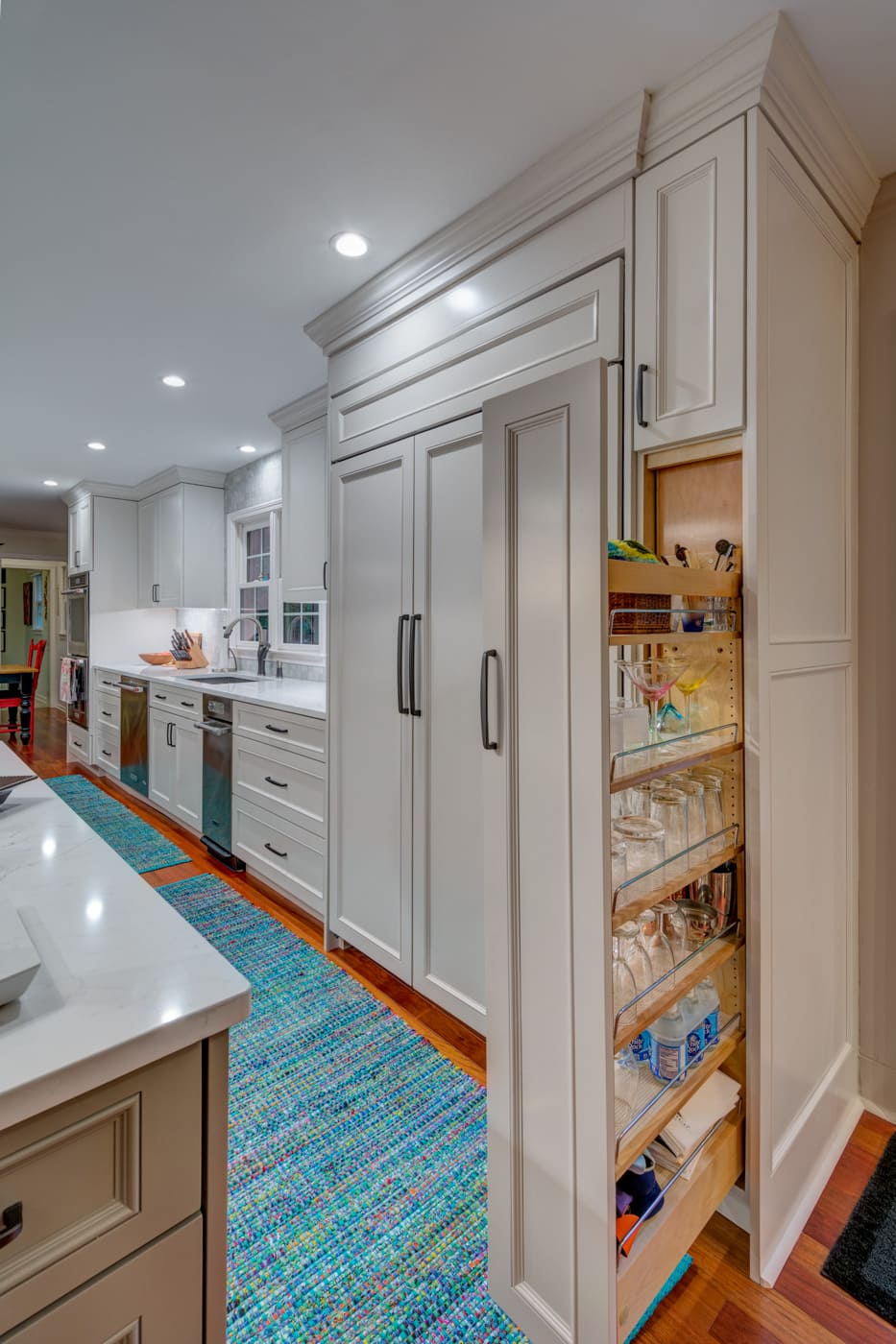 Innovative pantry storage in sleek custom kitchen by Silver Oak Remodeling in Atlanta