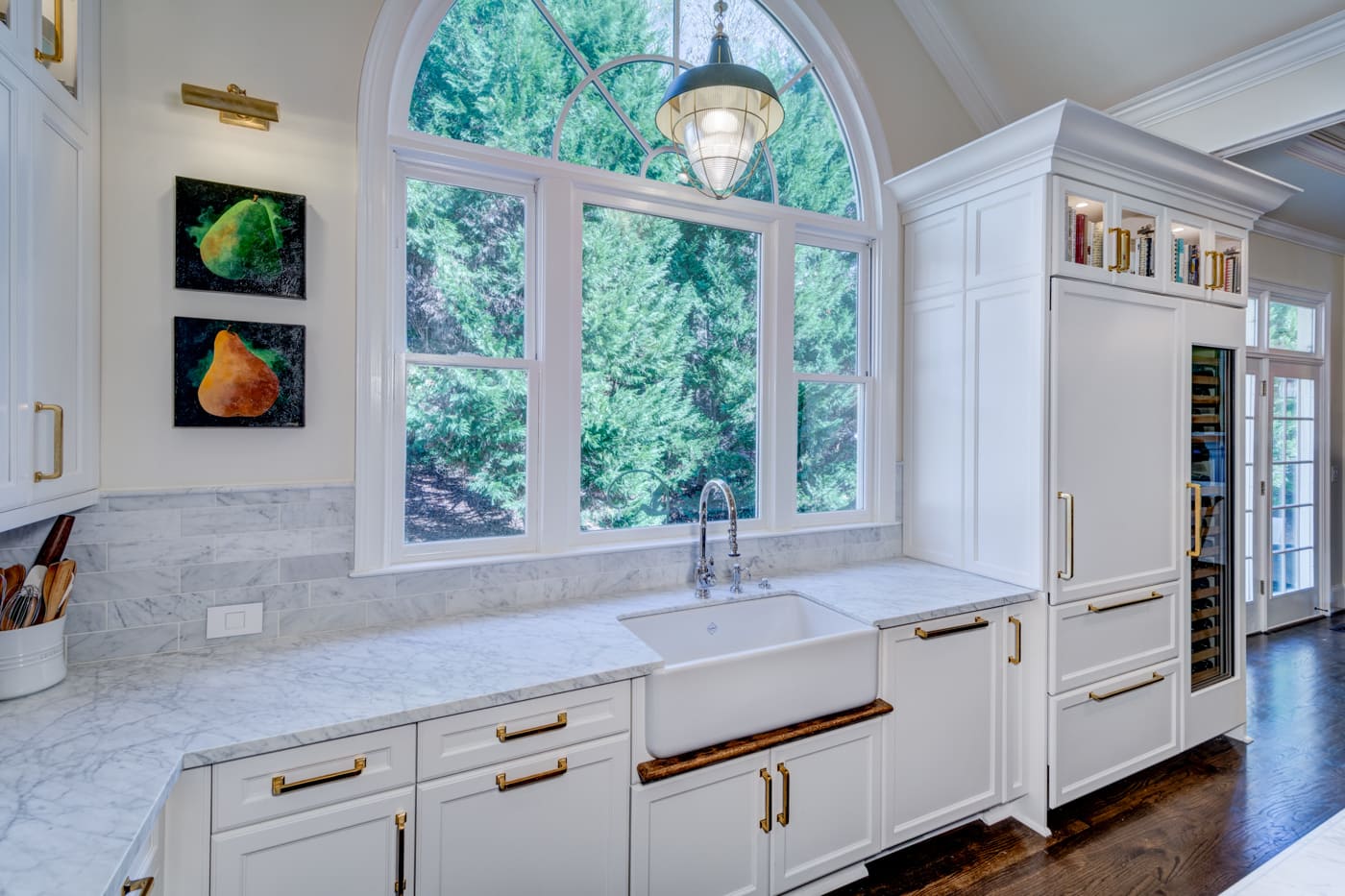 Kitchen design with marble backsplash and statement window in custom Atlanta home by Silver Oak Remodeling