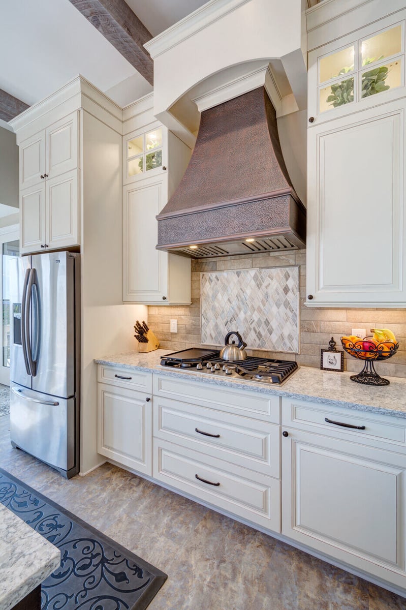 Kitchen detail shot from Silver Oak Remodel project in Atlanta, GA showcasing copper range hood and tile backsplash
