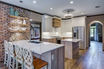 Kitchen with wood accents, floating shelves, and brick detail in Atlanta custom build by Silver Oak Remodeling