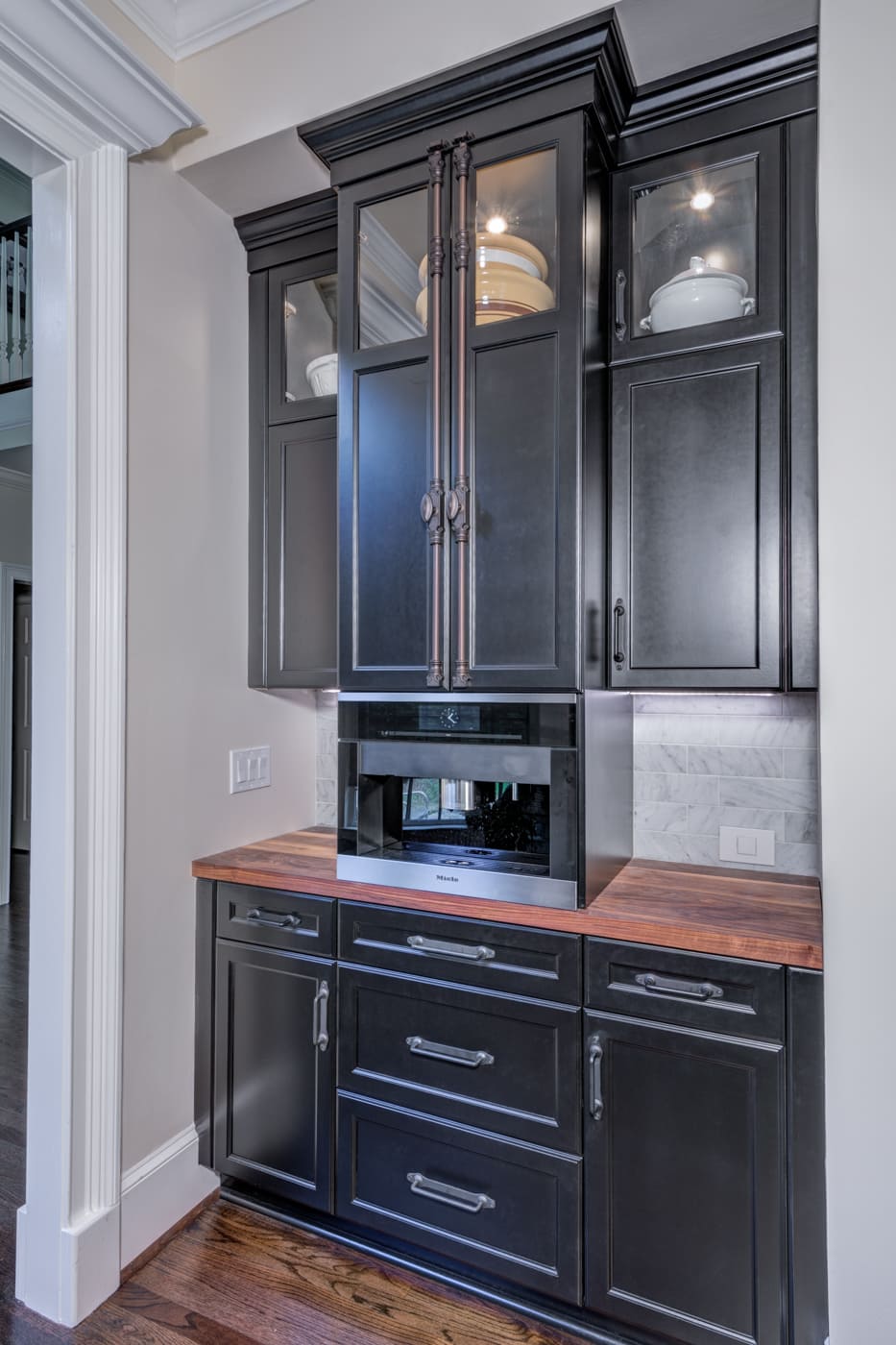 Miele coffee machine built into black cabinetry in custom Atlanta kitchen by Silver Oak Remodeling