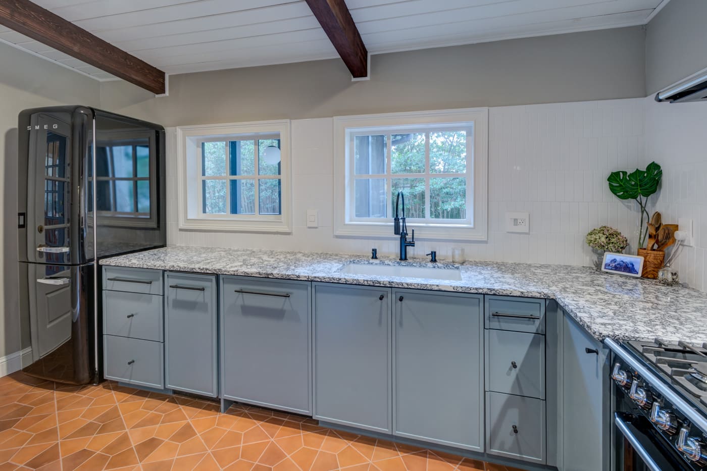 Renovated kitchen sink wall with ample storage and light tile backsplash in Atlanta home by Silver Oak Remodeling