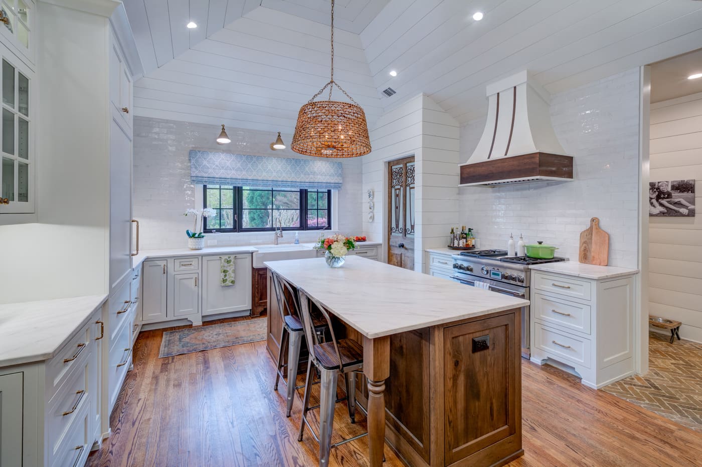 Bright farmhouse kitchen with wood island and vaulted shiplap ceiling by Silver Oak Remodeling in Atlanta, GA