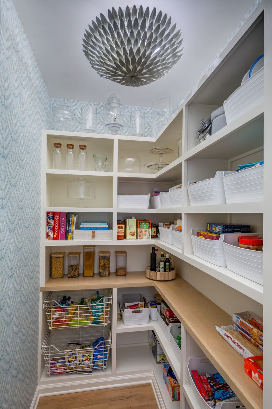 Organized pantry space with bright shelving and unique light fixture by Silver Oak Remodeling in Atlanta, GA