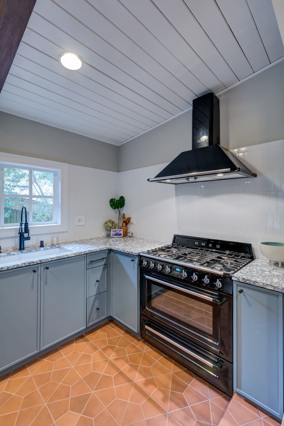 Stylish kitchen remodel in Atlanta with modern black range hood and granite counters by Silver Oak Remodeling