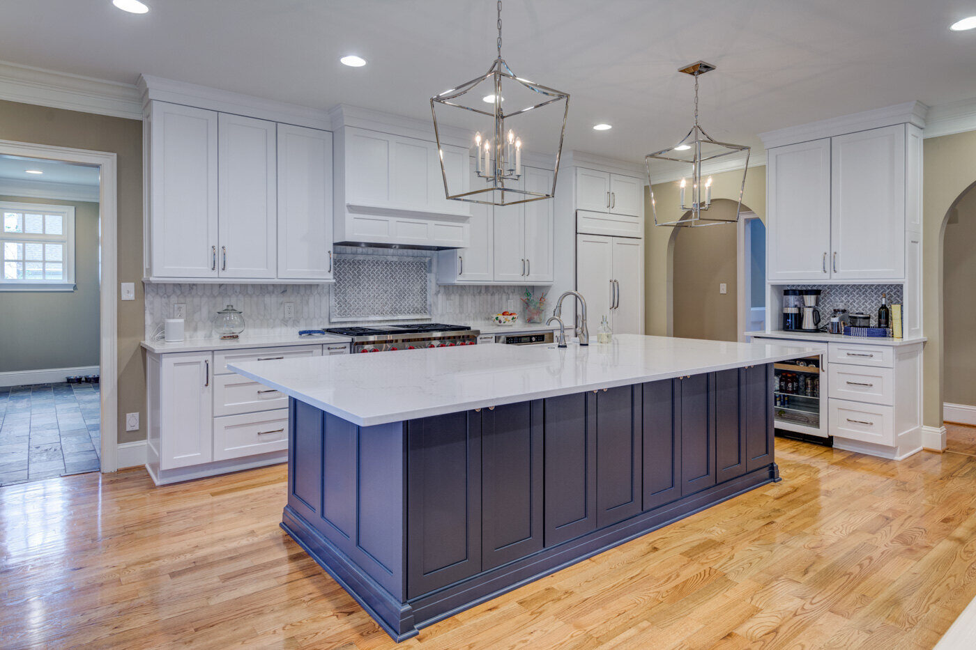 Transitional kitchen remodel in Atlanta, GA by Silver Oak Remodel with navy island and white cabinets