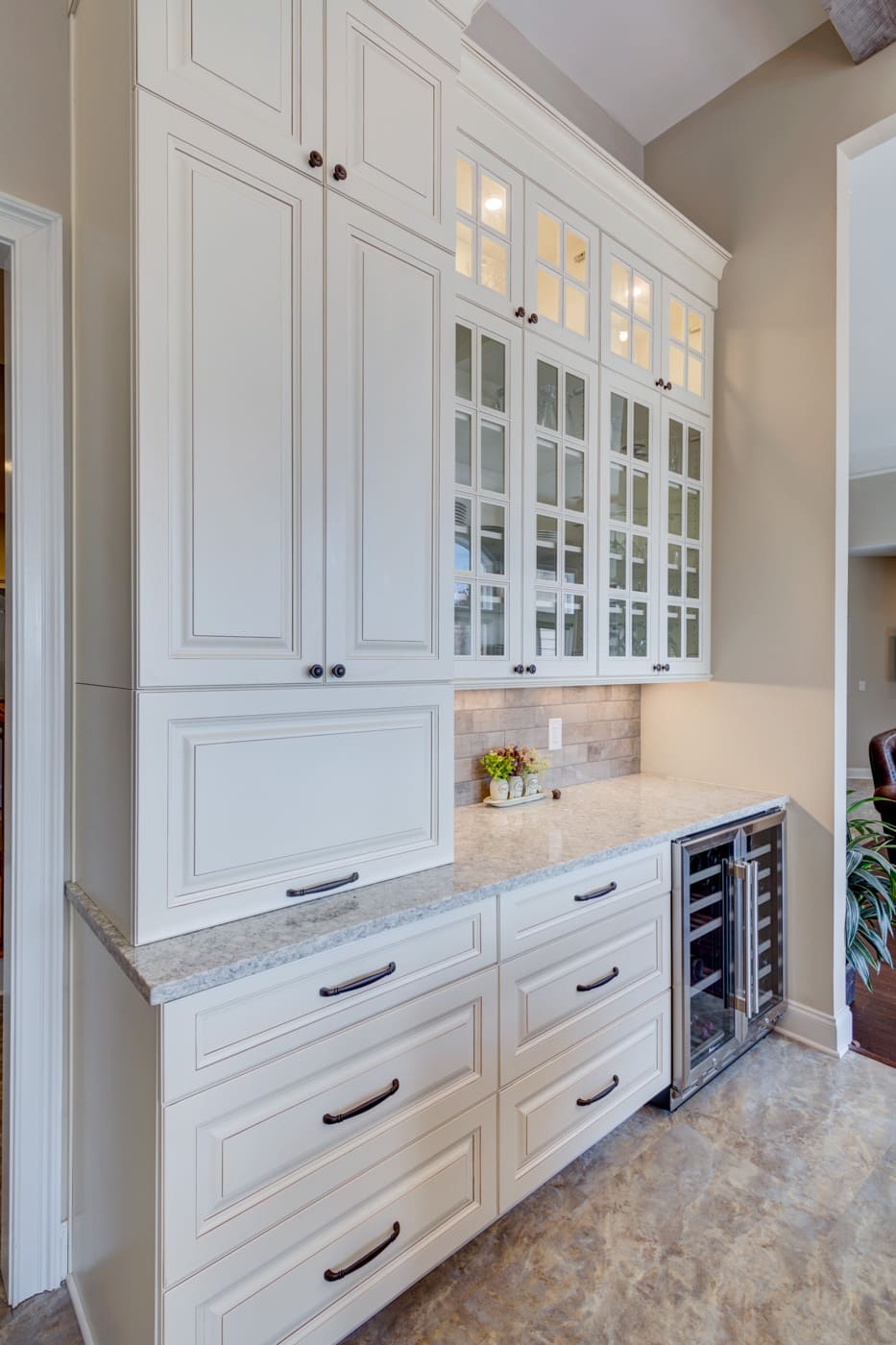 White cabinets with glass upper doors and granite counters in Silver Oak Remodeling kitchen remodel in Atlanta, GA