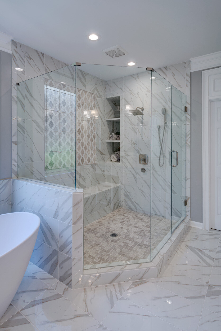 Luxurious walk-in shower with marble tile in bathroom remodel by Silver Oak Remodel in Sandy Springs, GA