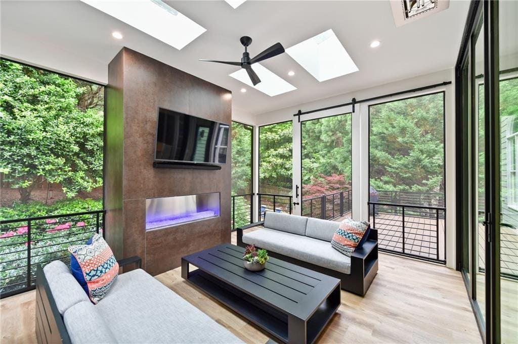 Sleek indoor-outdoor living space with black-framed windows in a custom home by Silver Oak Remodeling, Atl
