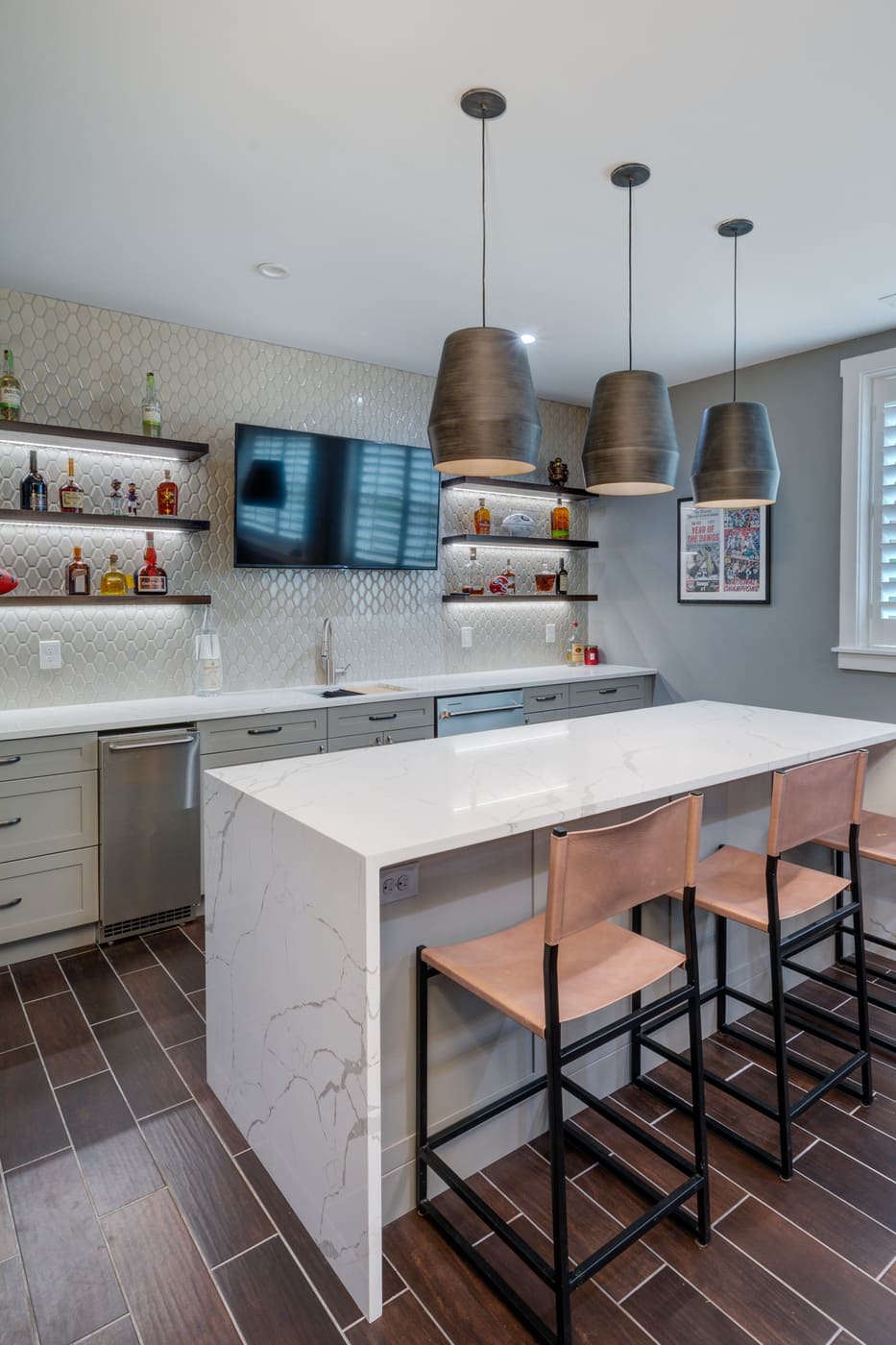 Basement bar with pendant lighting in custom Atlanta home by Silver Oak Remodeling