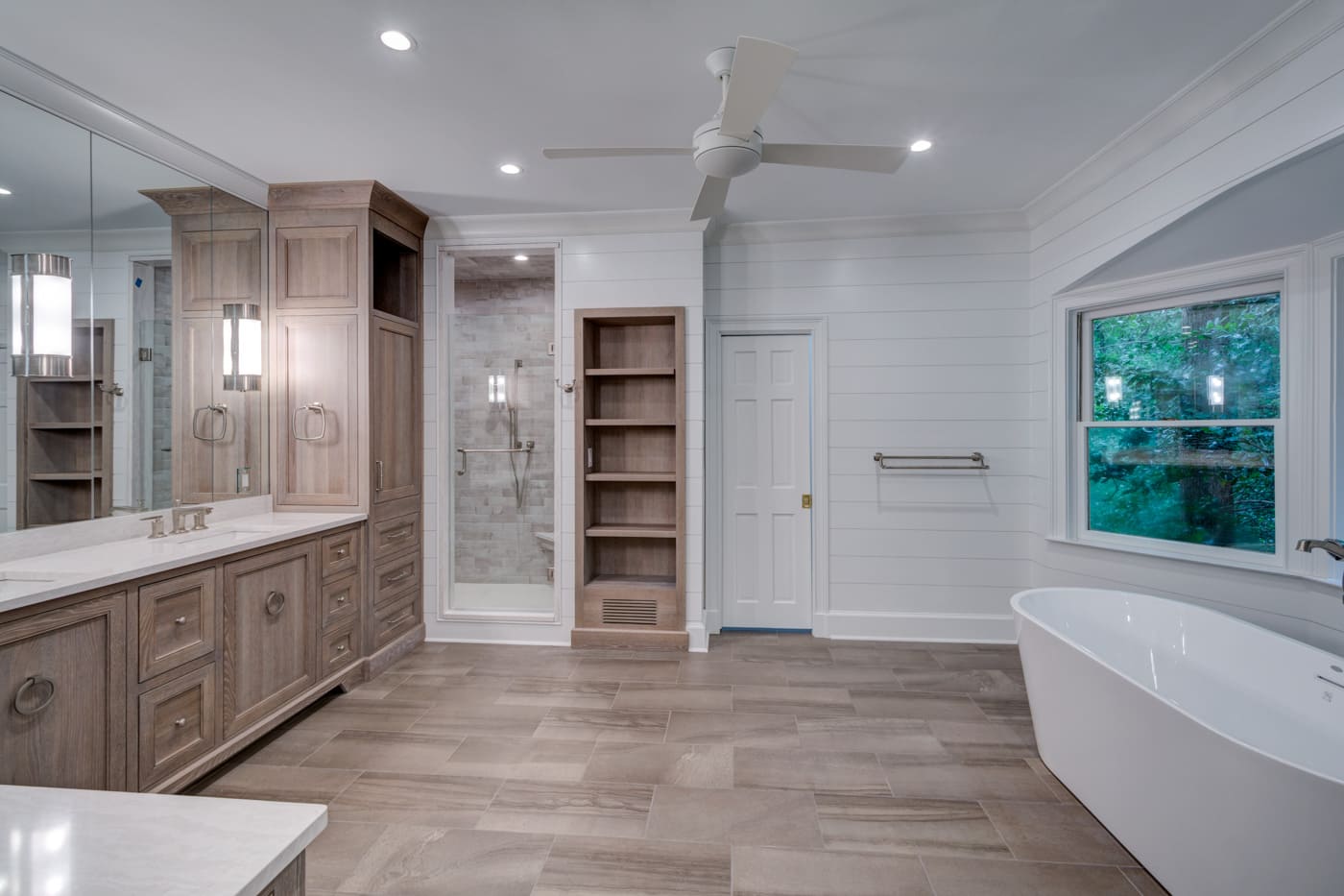 Neutral-toned bathroom with wood vanity and walk-in shower by Silver Oak Remodeling in Atlanta, GA