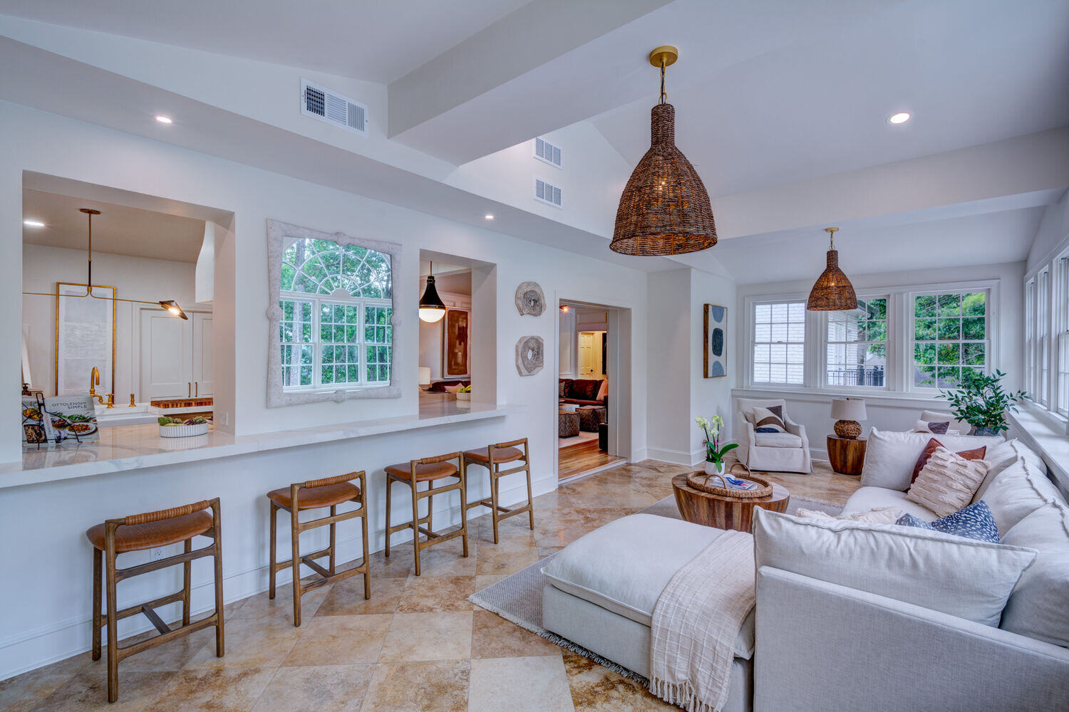Spacious sunroom with bar seating and pendant lights by Silver Oak Remodel in Brookfield