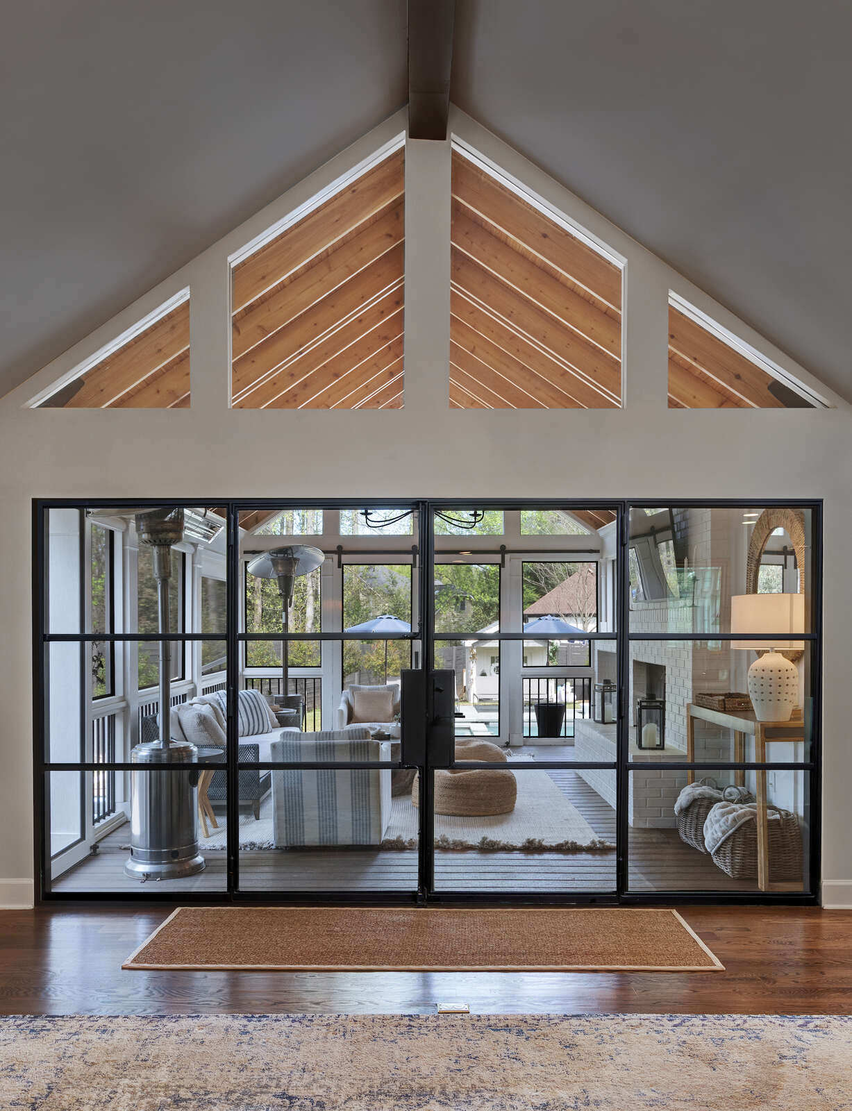 View from inside East Cobb home looking into porch addition by Silver Oak Remodel with glass door wall