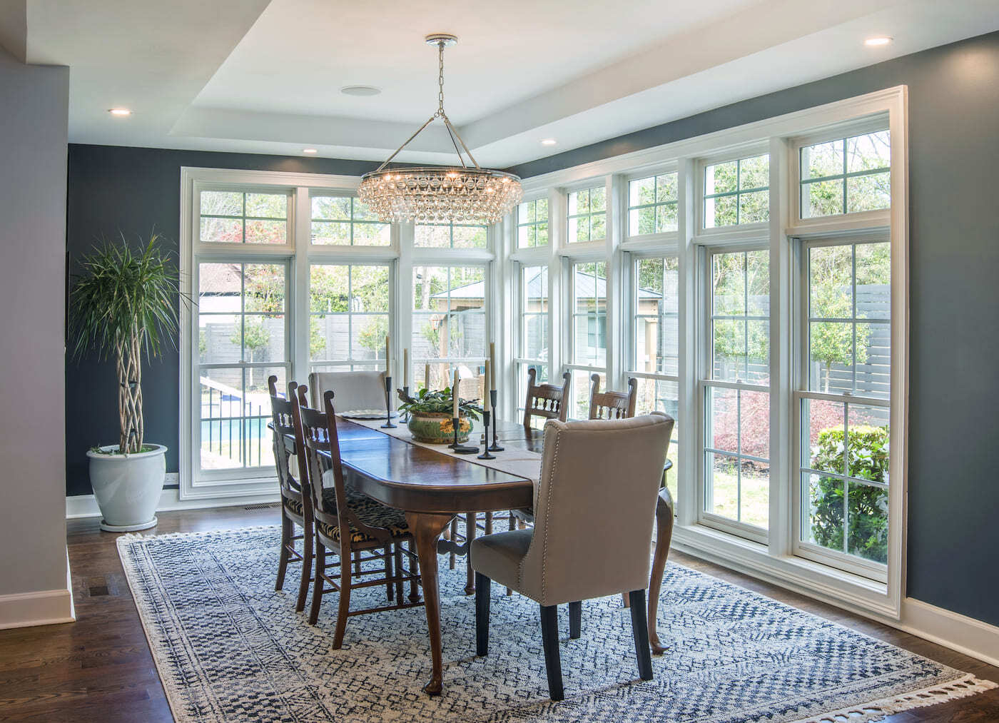 Corner dining space with crystal chandelier in Atlanta remodel by Silver Oak Remodeling