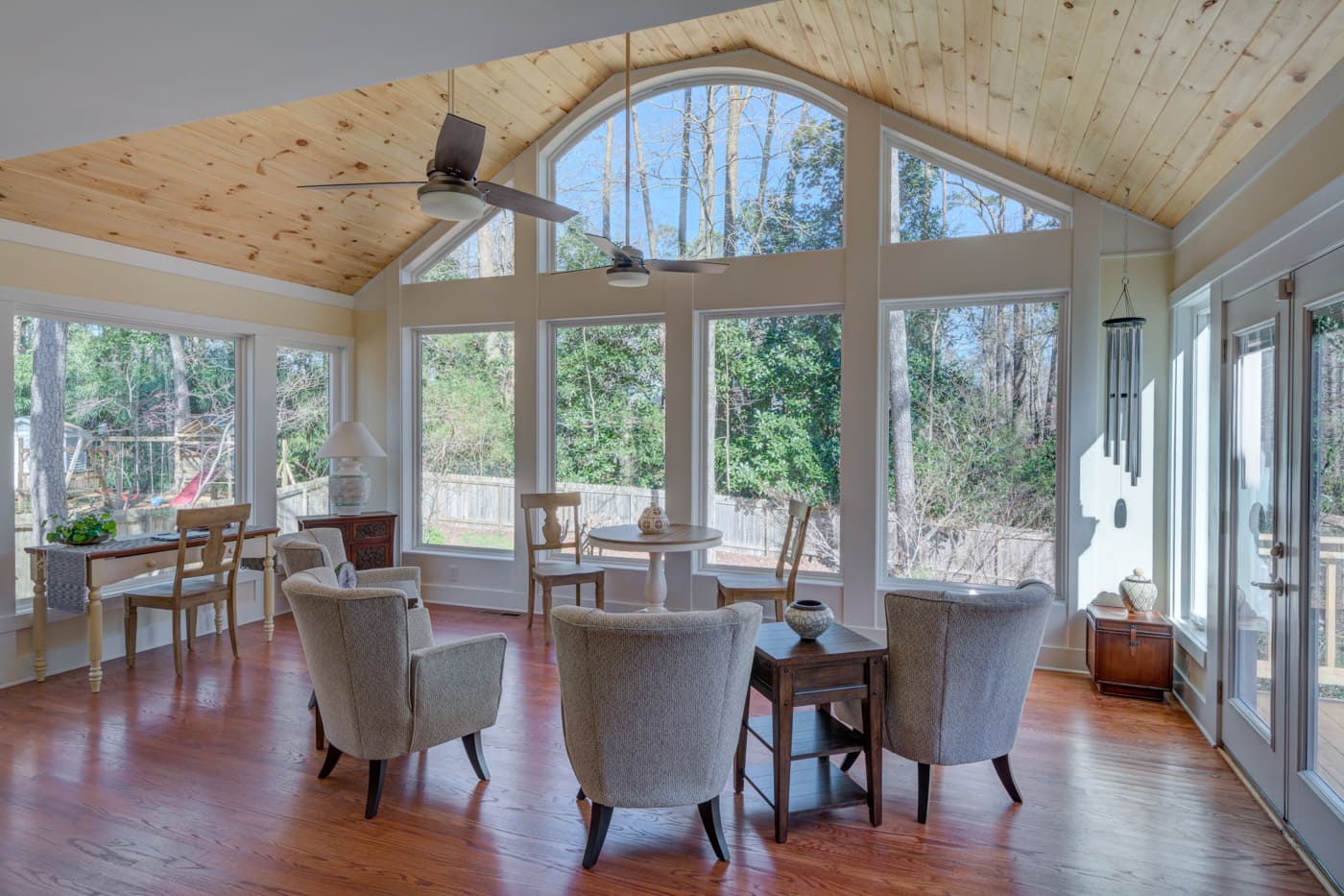 Sunroom with wood ceiling and large windows in Atlanta custom home by Silver Oak Remodeling
