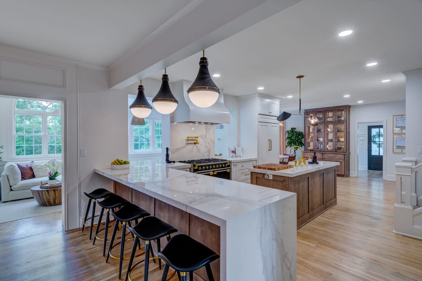 Open-concept kitchen with island seating and pendant lights by Silver Oak Remodeling in Atlanta, GA