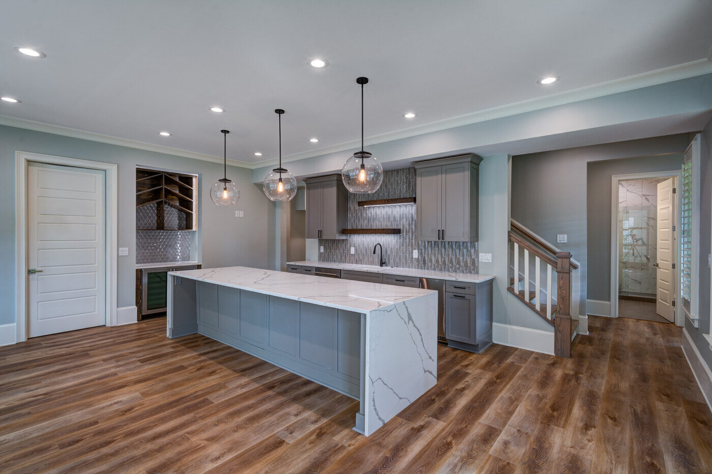Sleek modern kitchen remodel in Atlanta, GA by Silver Oak Remodel with oversized marble island