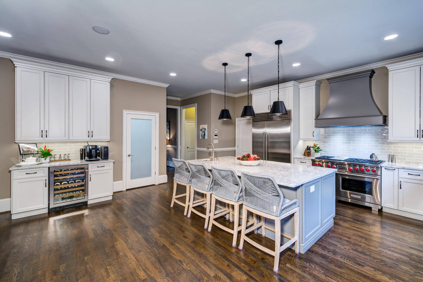 Luxury kitchen renovation in Atlanta, GA with white cabinetry, marble island, and pendant lighting by Silver Oak Remodel